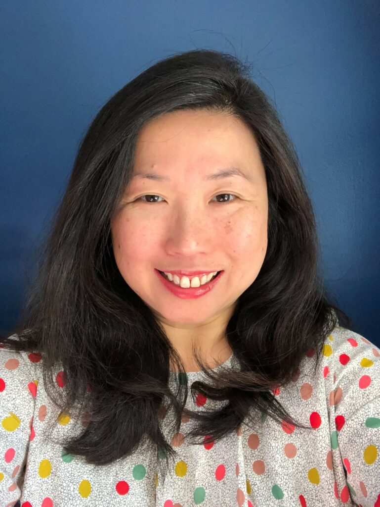 Headshot image of author/illustrator Pat Tanumihardja in a colorful polka do shirt.