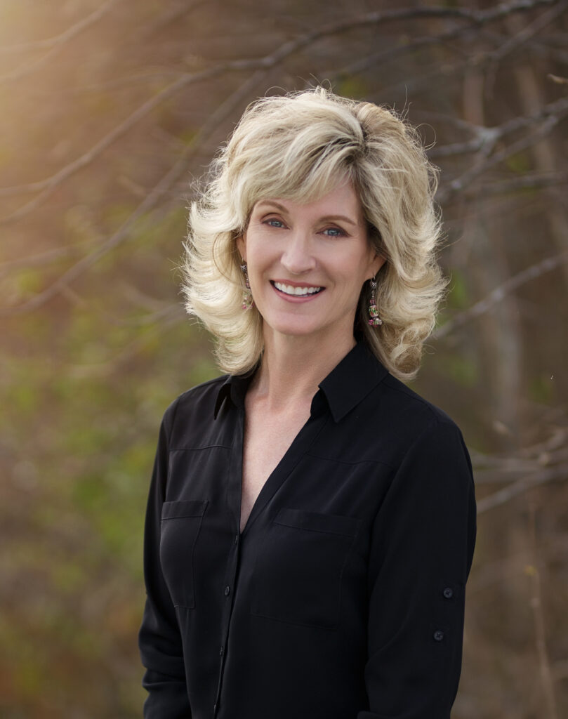 Image of children's author Tina Shepardson in front of a hazy background of a tree