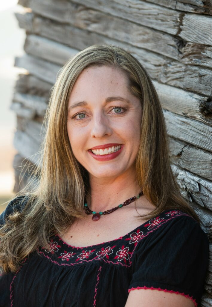 Image of children's book author of A.J. Irving in front of a wood slat wall.